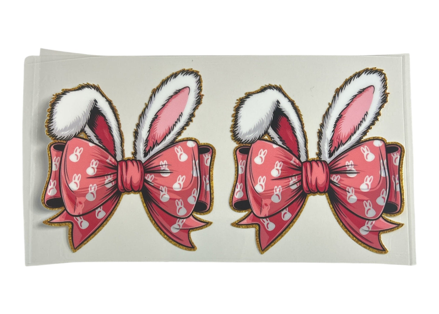 Two pink bows with bunny ears on a white background