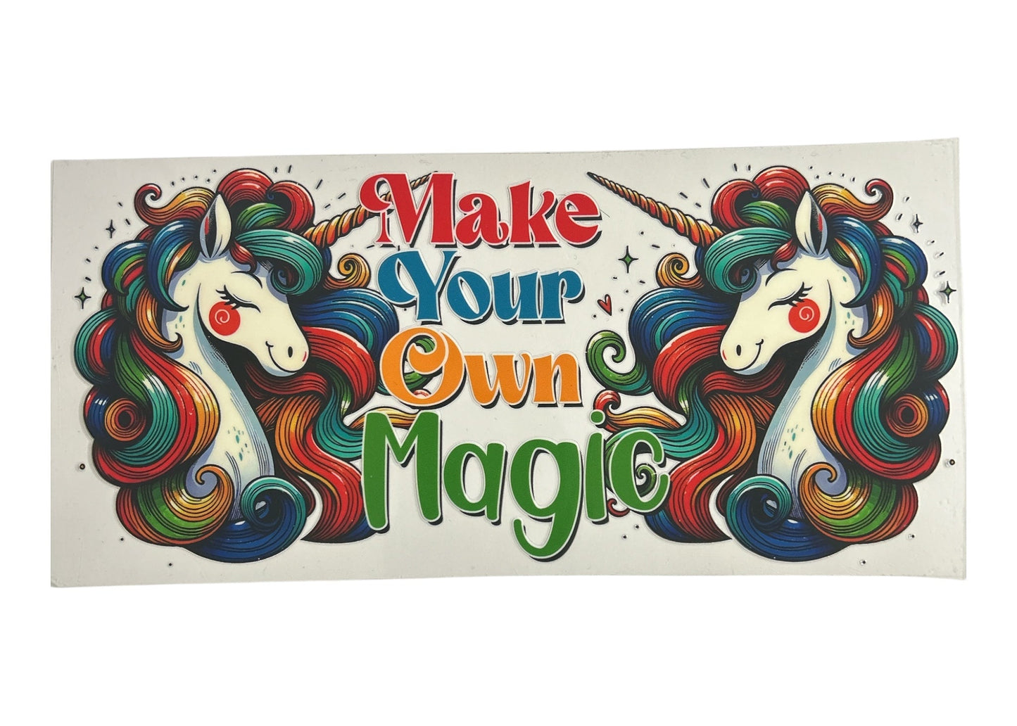 Colorful sticker with unicorns and 'Make Your Own Magic' text on a white background