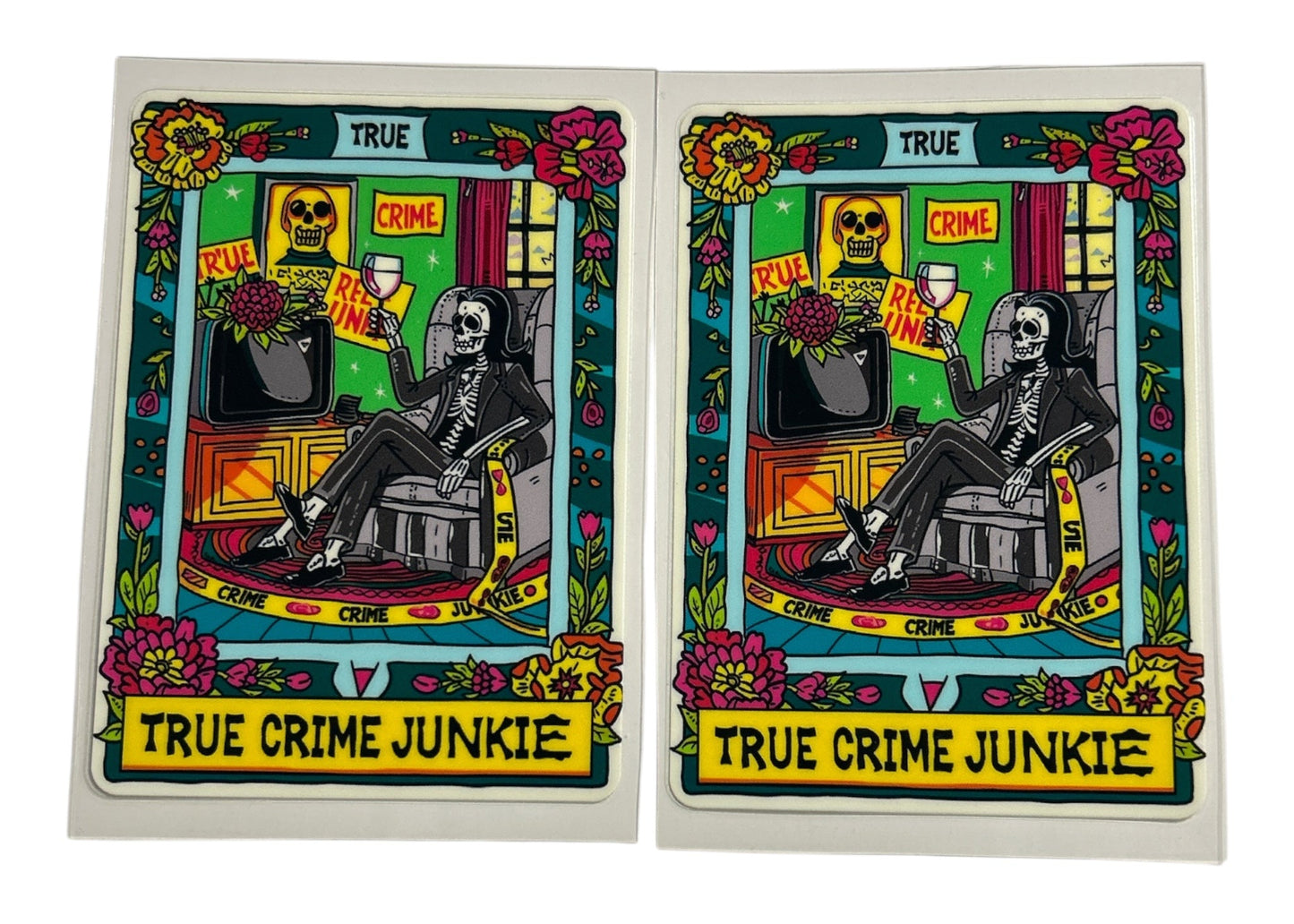Two identical cards featuring a skeleton, flowers, and text on a white background