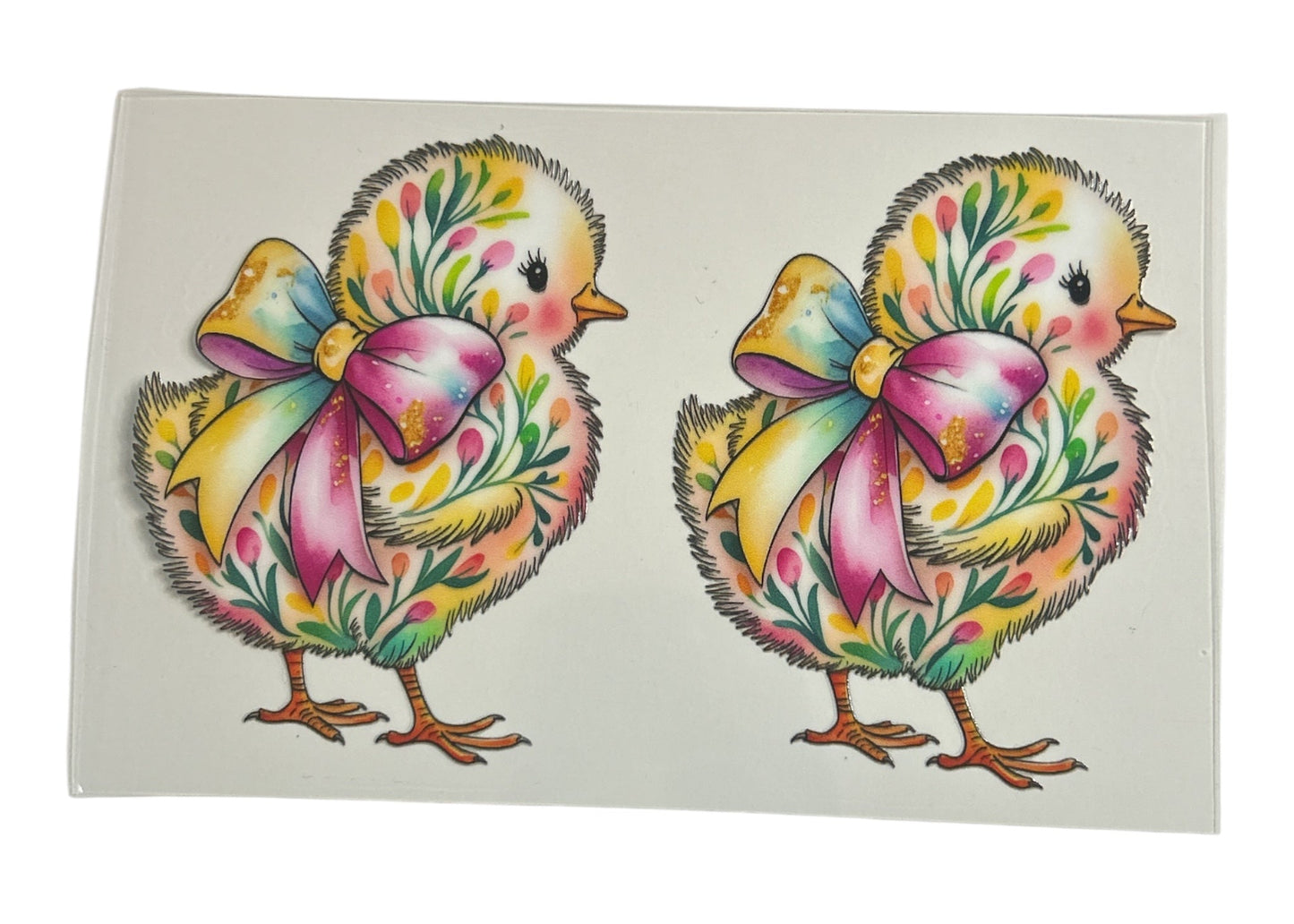Two colorful chick illustrations with floral bows on a white background