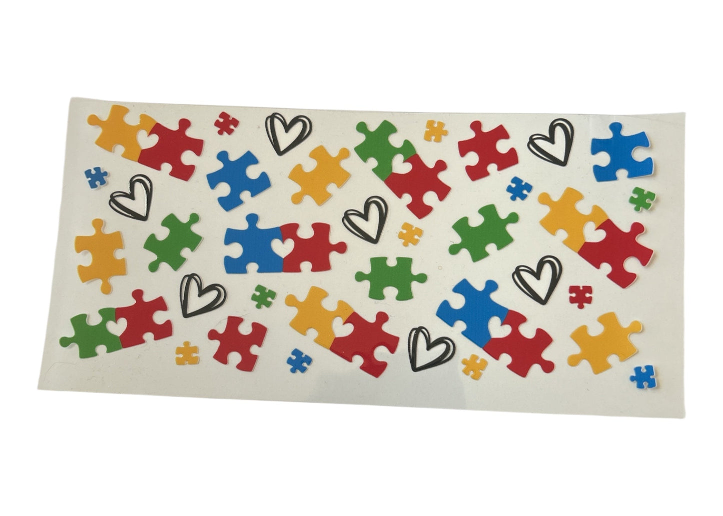 Colorful puzzle piece and heart pattern on a white background