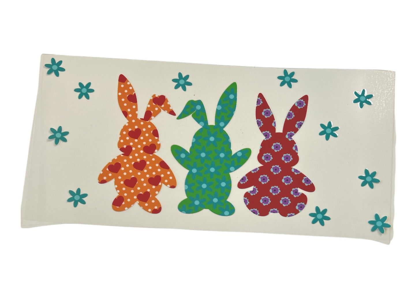 Decorative cup wrap with colorful bunny designs on a white background