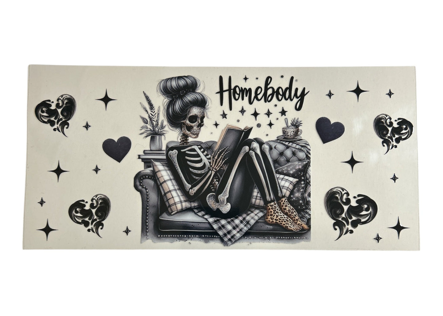 Skeletal character lounging on a couch with decorative elements and 'Homebody' text on a beige background.
