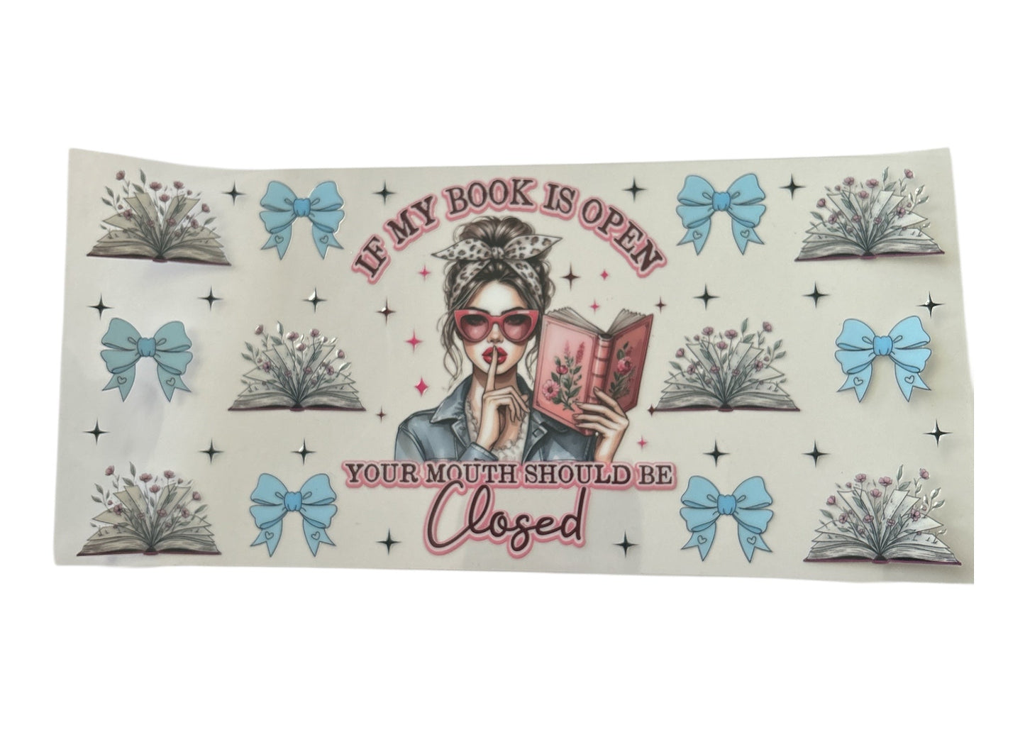 Cup wrap with a design of a woman reading a book and text 'If my book is open, your mouth should be closed' on a white background.