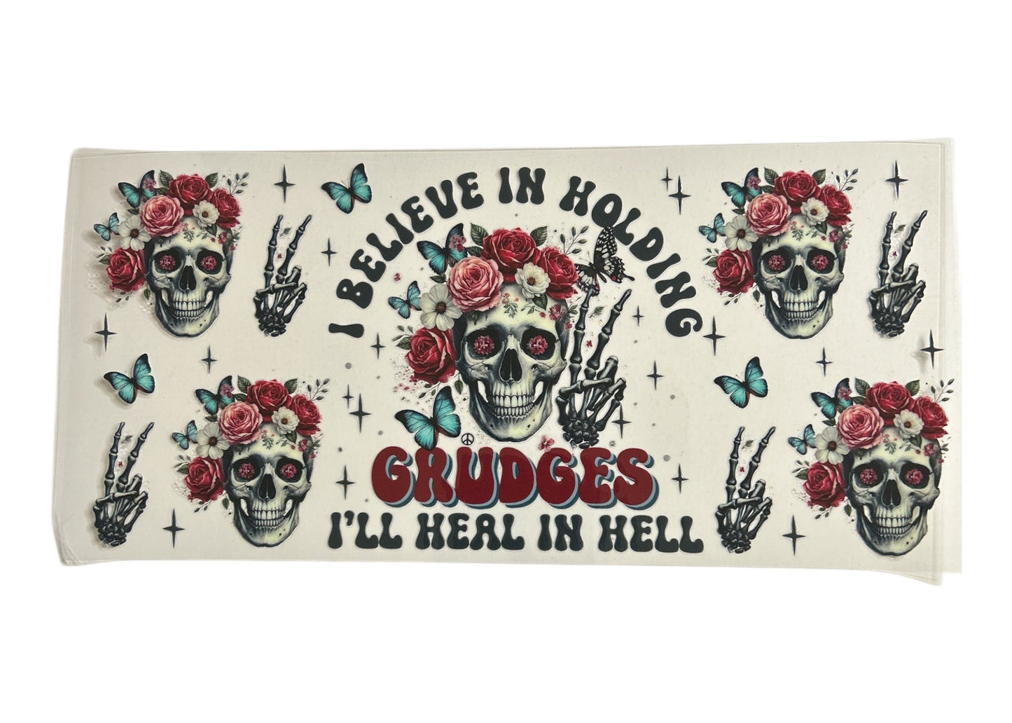Cup wrap with skull designs, flowers, and text on a white background