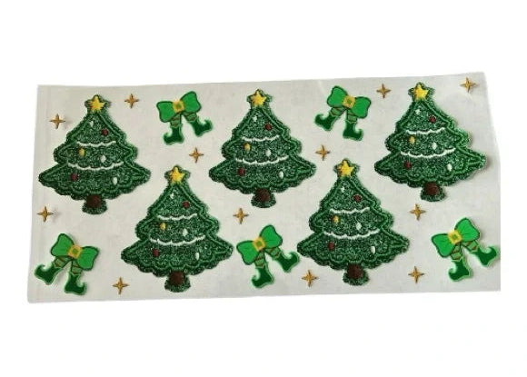 Sheet of green Christmas tree stickers with decorative elements on a clear background