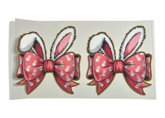 Two pink bows with bunny ears on a white background