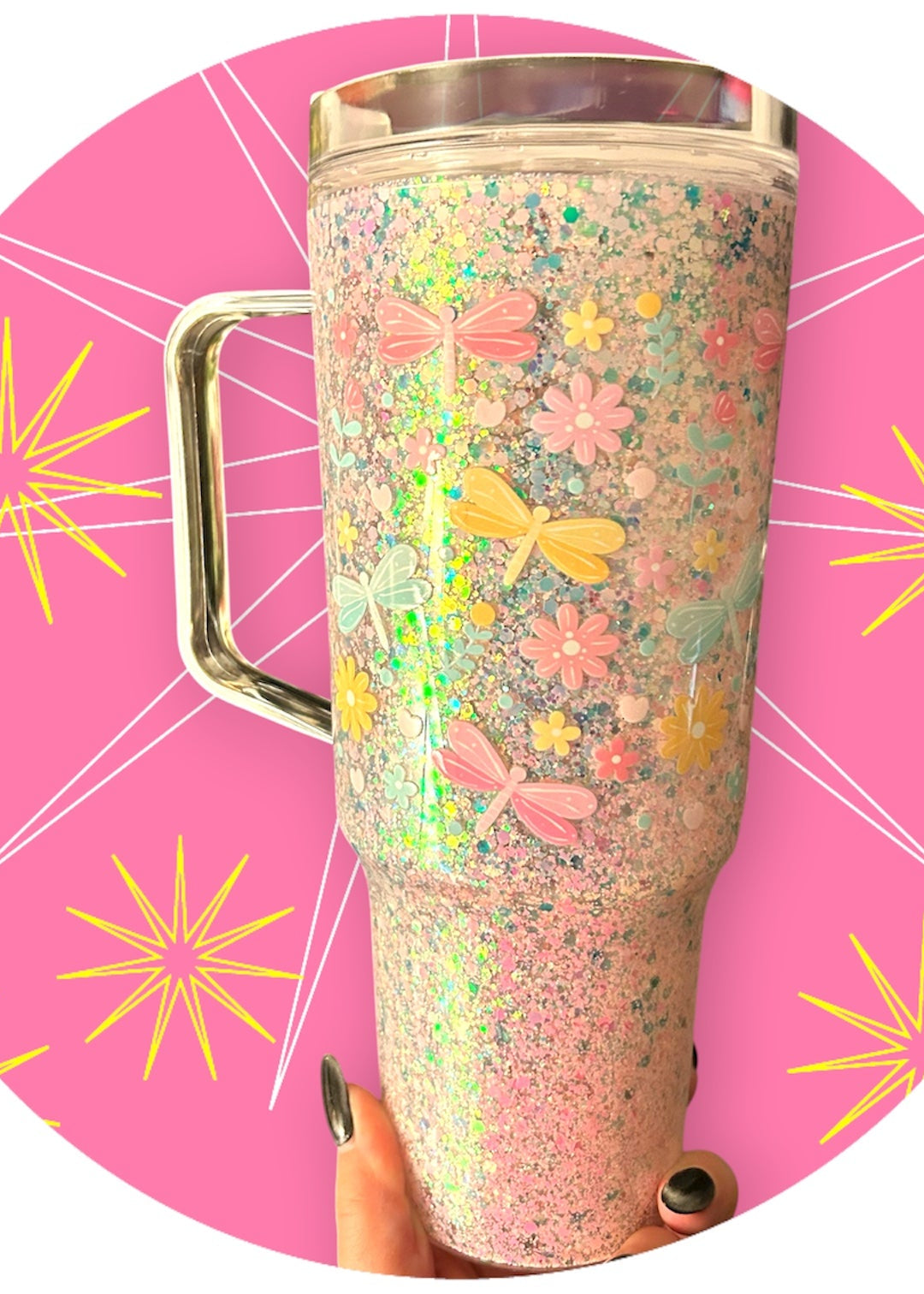 Decorative tumbler with floral and butterfly pattern on a pink background