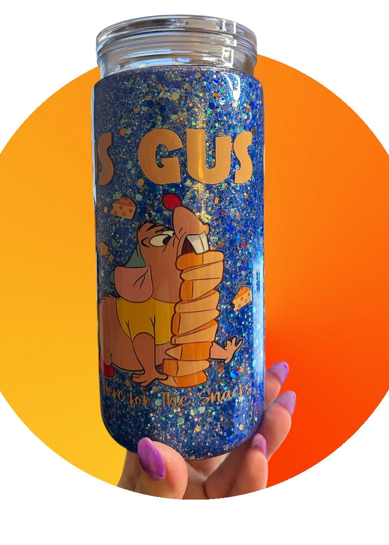 Tumbler with cartoon character design held against a colorful background