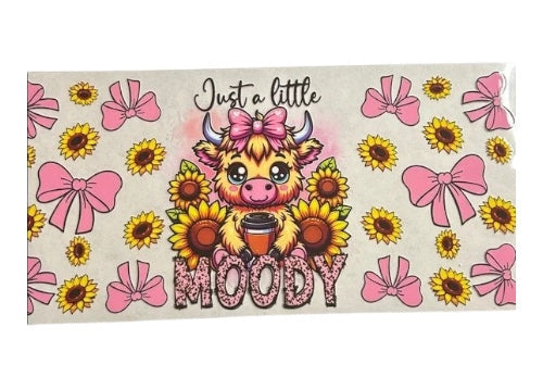 Cartoon cow with a coffee cup surrounded by sunflowers, pink bows, and text on a beige background.