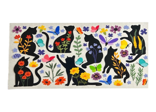 Decorative cup wrap with black cats, flowers, and butterflies on a white background