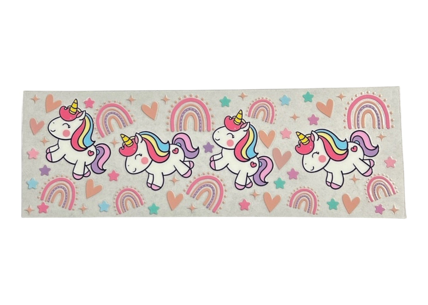 Clear cup wrap with unicorn and rainbow designs on a clear background