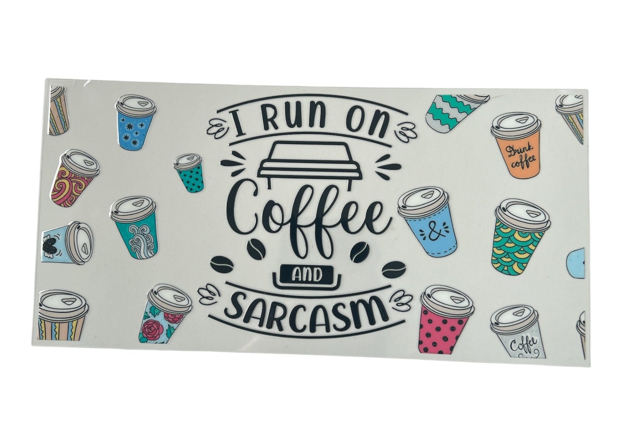 Rectangular decal with coffee cup illustrations and text 'I run on coffee and sarcasm' on a white background