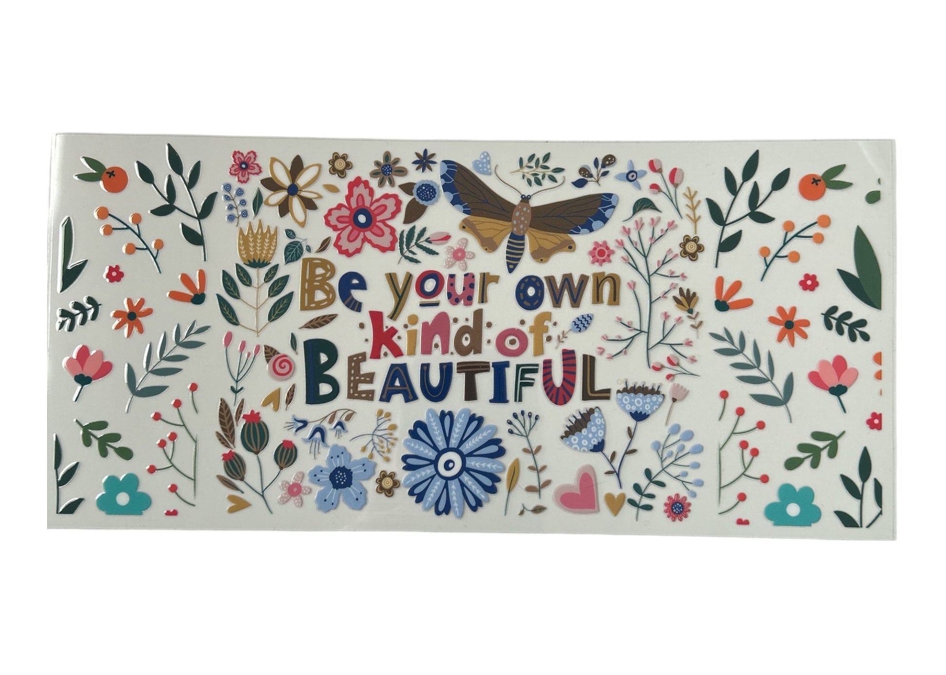 Decorative cup wrap with floral designs and motivational text on a white background