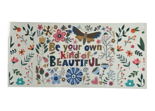 Decorative cup wrap with floral designs and motivational text on a white background