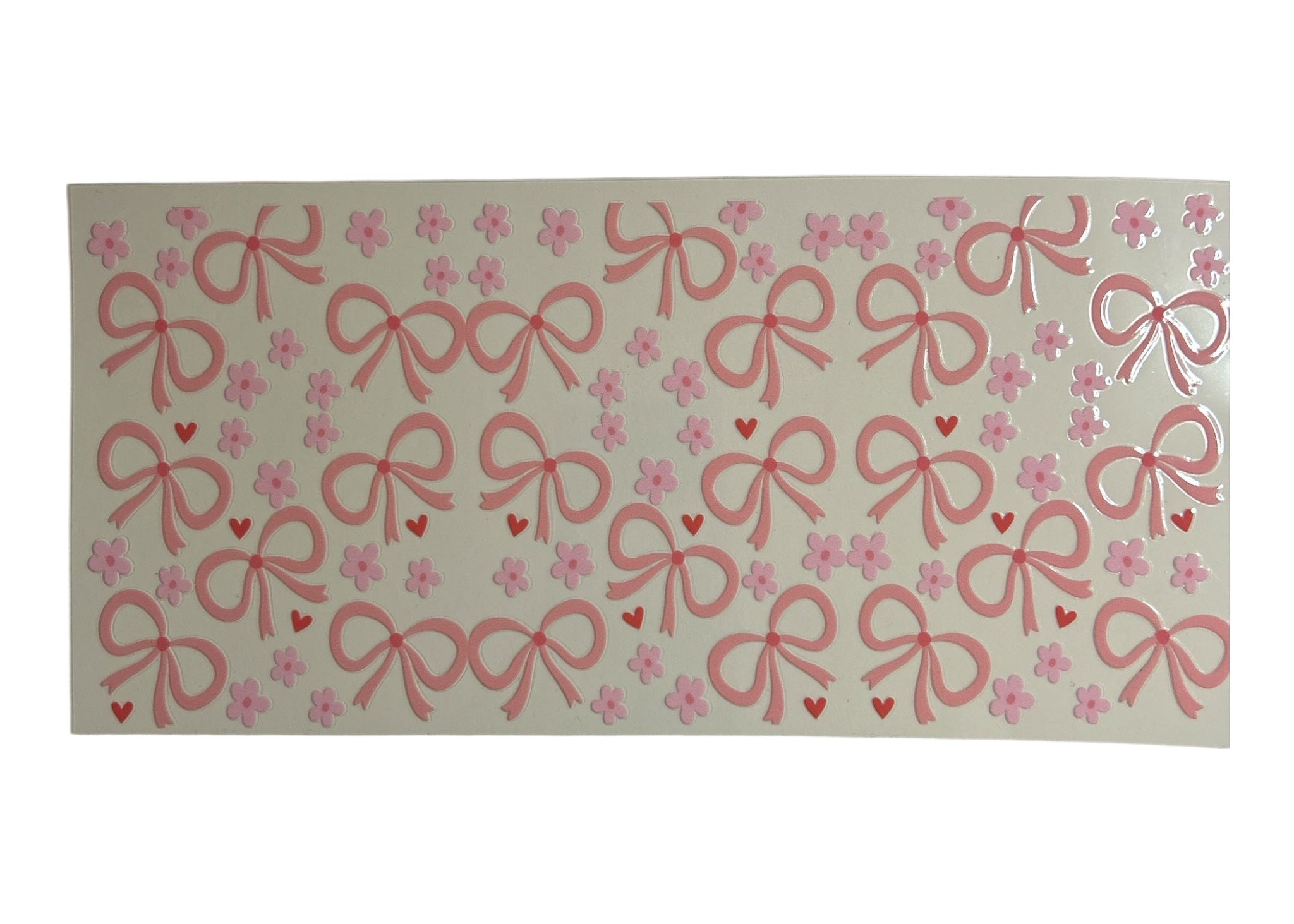 Rectangular cup wrap with pink bow and heart pattern on a clear background