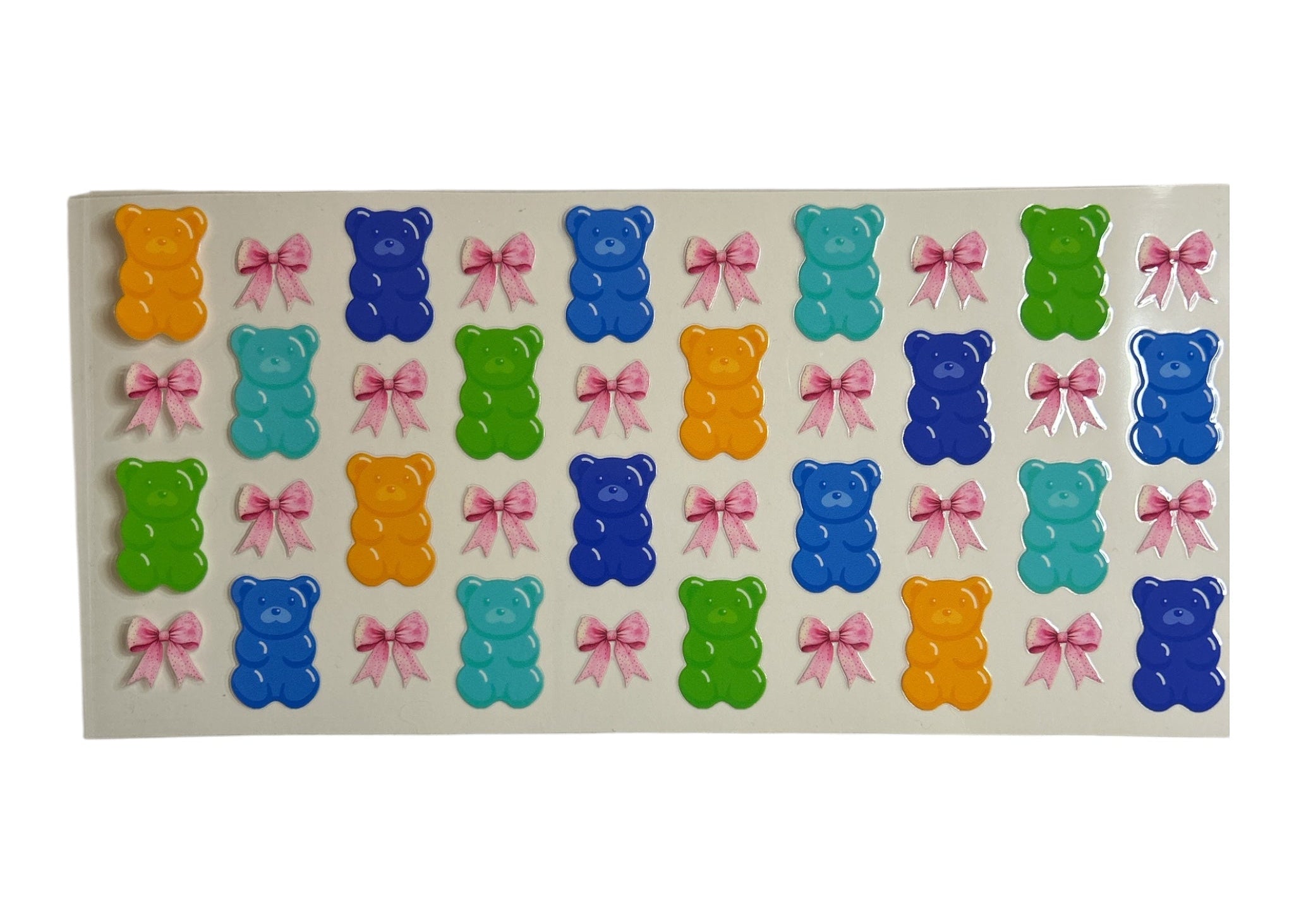 Sheet of colorful gummy bear and bow stickers on a clear background