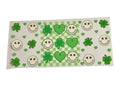 Decorative cup wrap with green shamrocks, hearts, and smiley faces on a checkered background