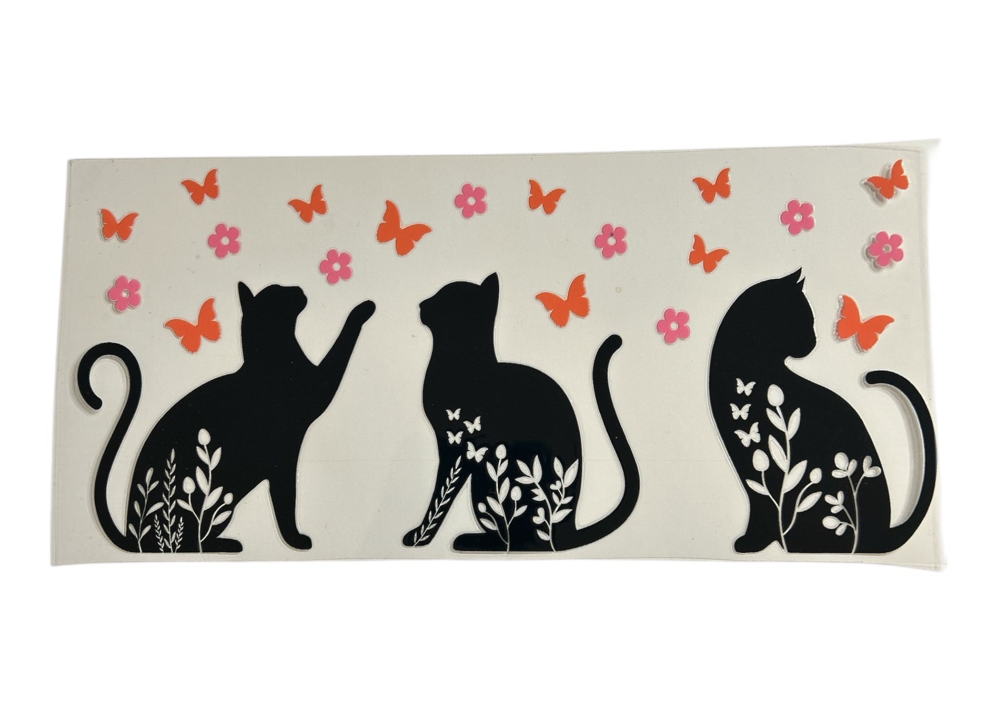 Decorative sticker with black cat silhouettes, flowers, and butterflies on a clear background