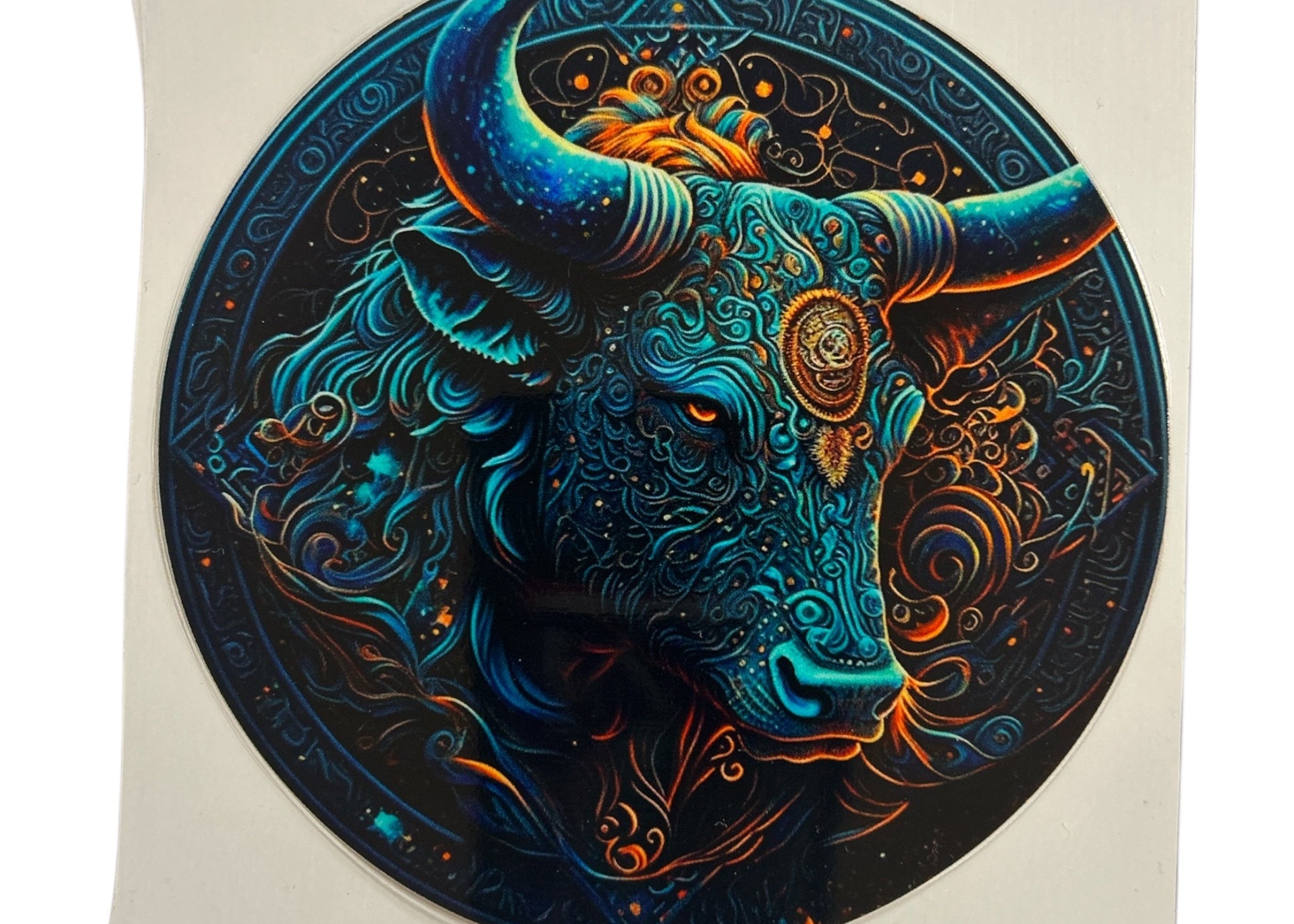 Decorative decal with a Taurus bull head design on a clear background