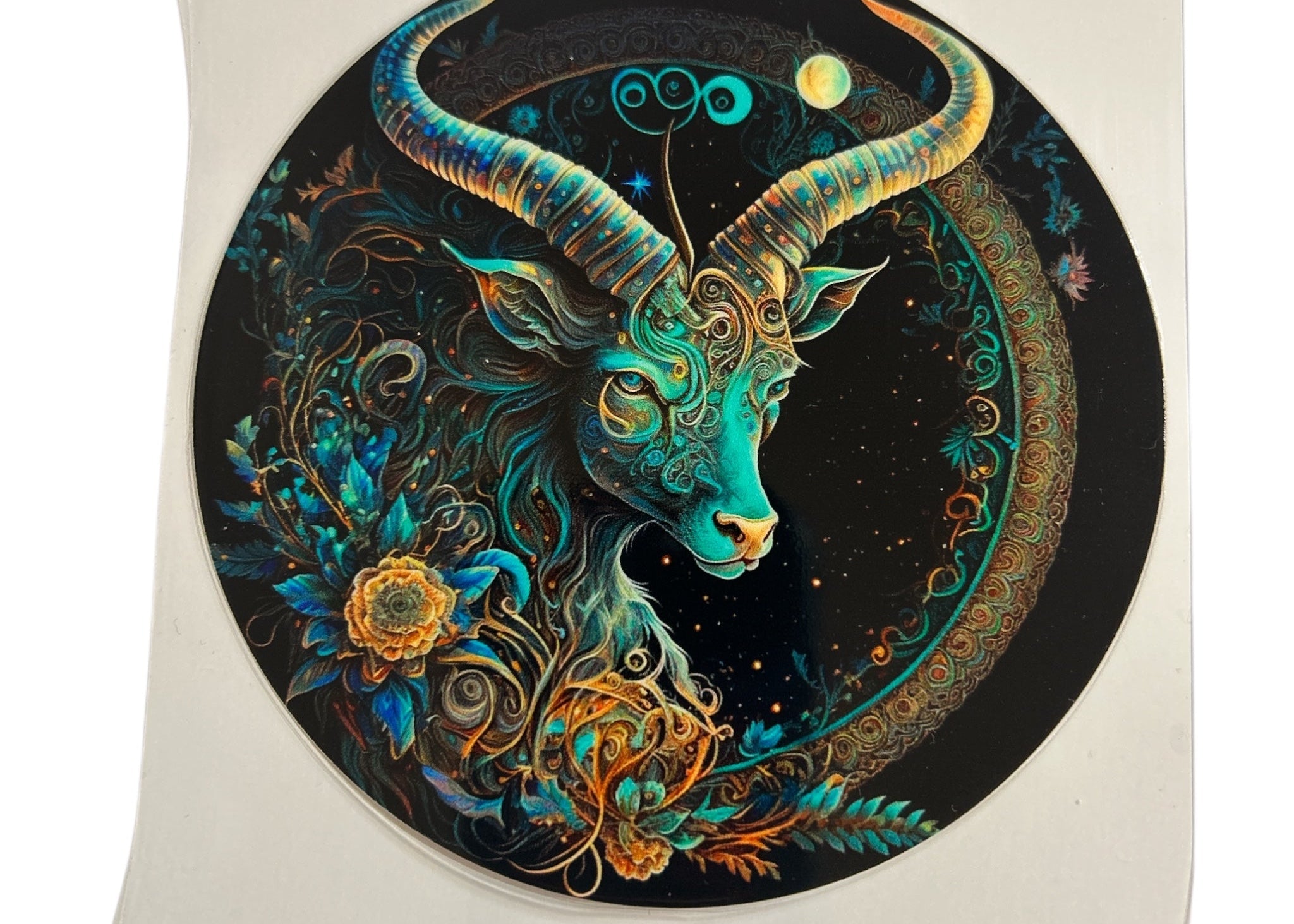 Decorative circular design with a stylized Capricorn and intricate patterns on a black background.