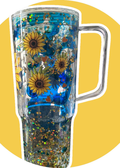 Clear tumbler with sunflower design on a yellow background