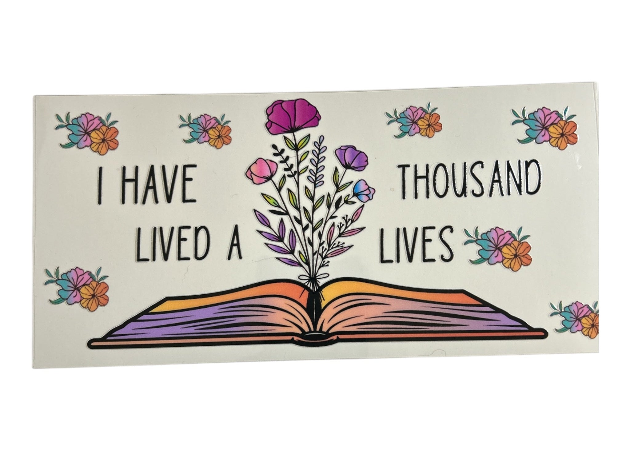 Decorative cup wrap with an open book design, flowers, and text on a white background