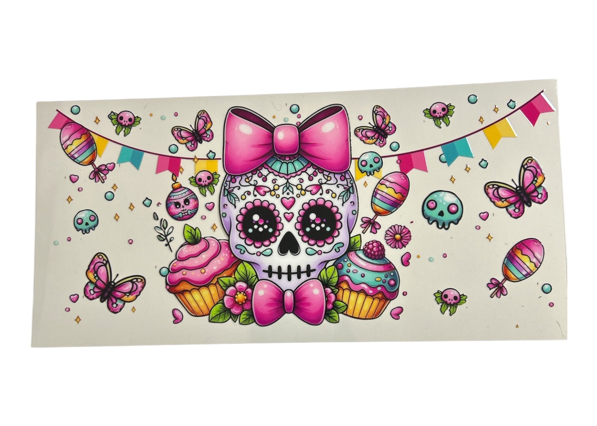 Colorful skull design with pink bow, cupcakes, and butterflies on a white background