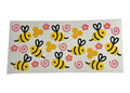 Cup wrap featuring bumblebees, honeycombs, and pink swirls on a clear background