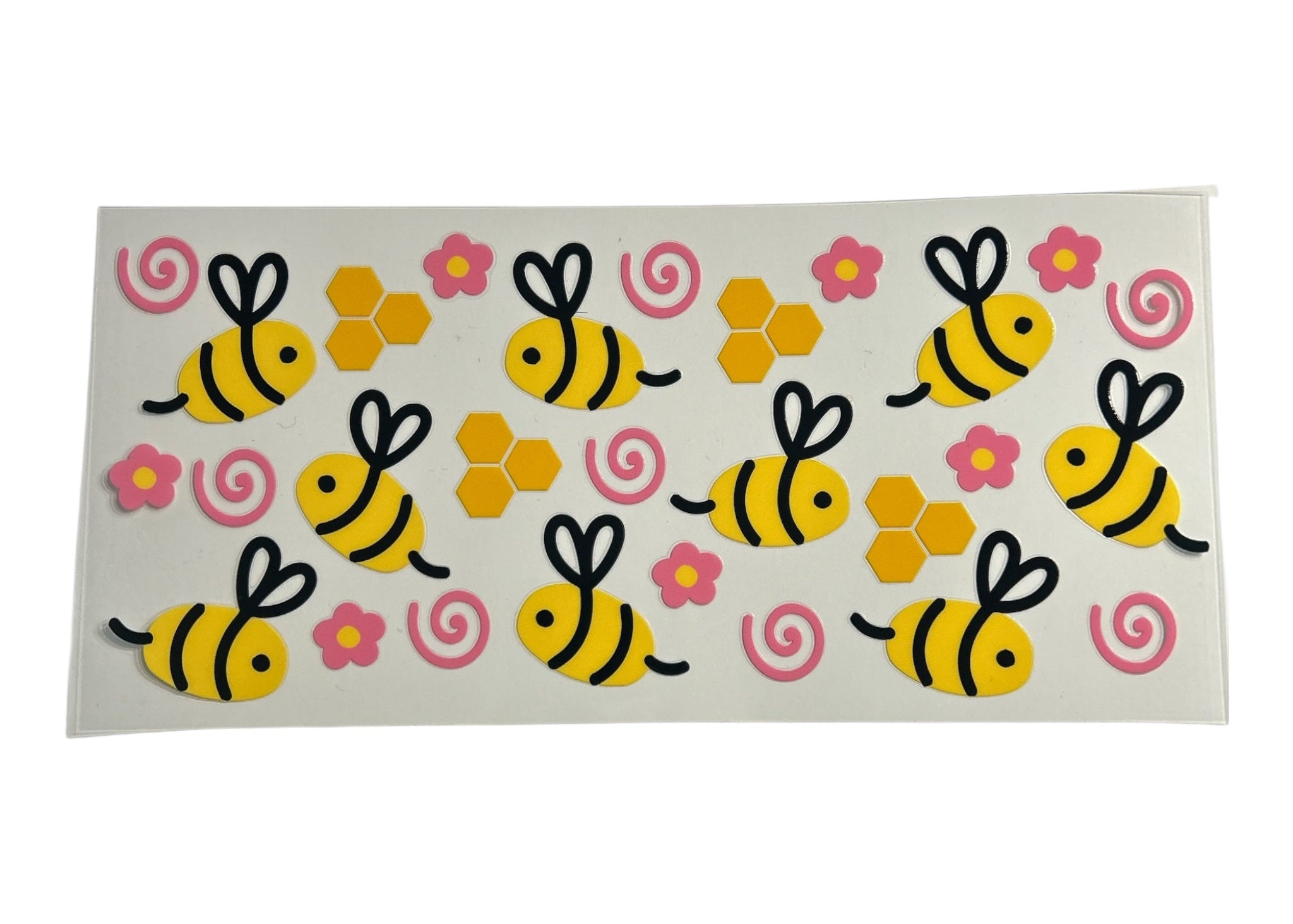 Cup wrap featuring bumblebees, honeycombs, and pink swirls on a clear background