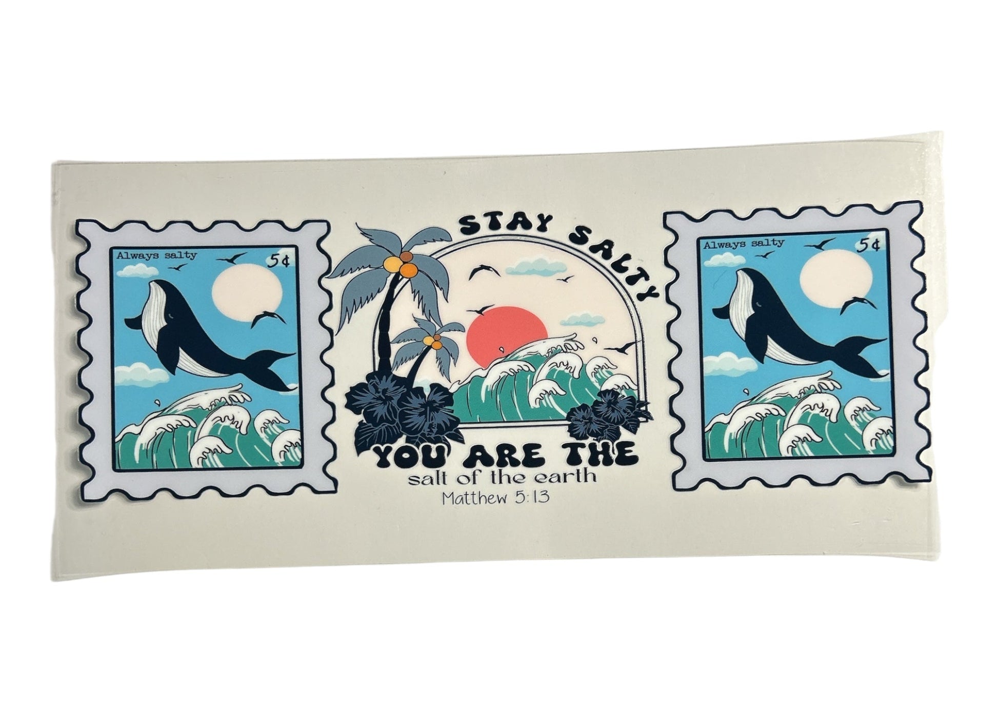 Decorative cup wrap with ocean-themed design featuring whales and palm trees on a clear background and text of a bible verse.