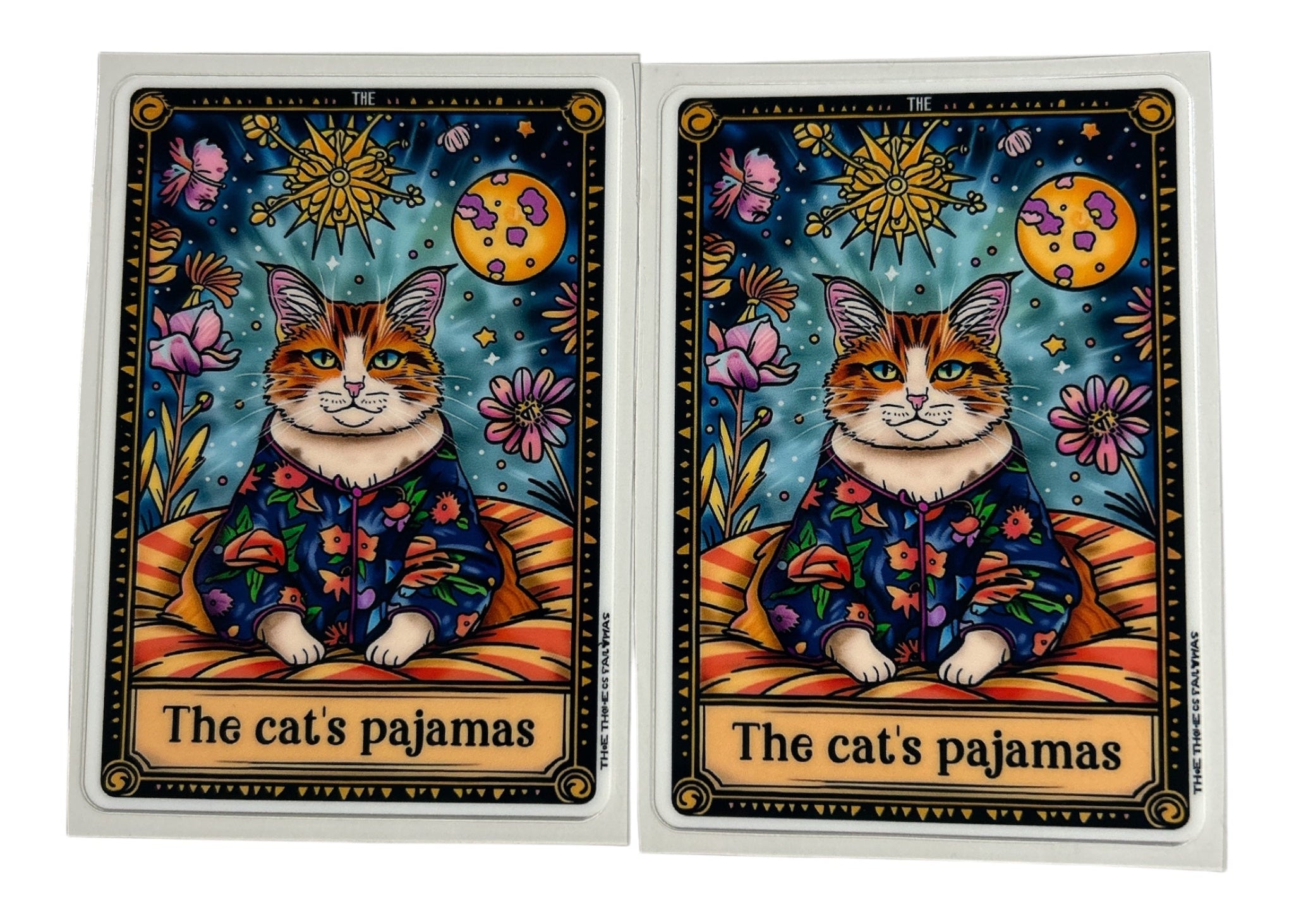 Two tarot card decals featuring a cat in pajamas with a celestial design on a clear background.