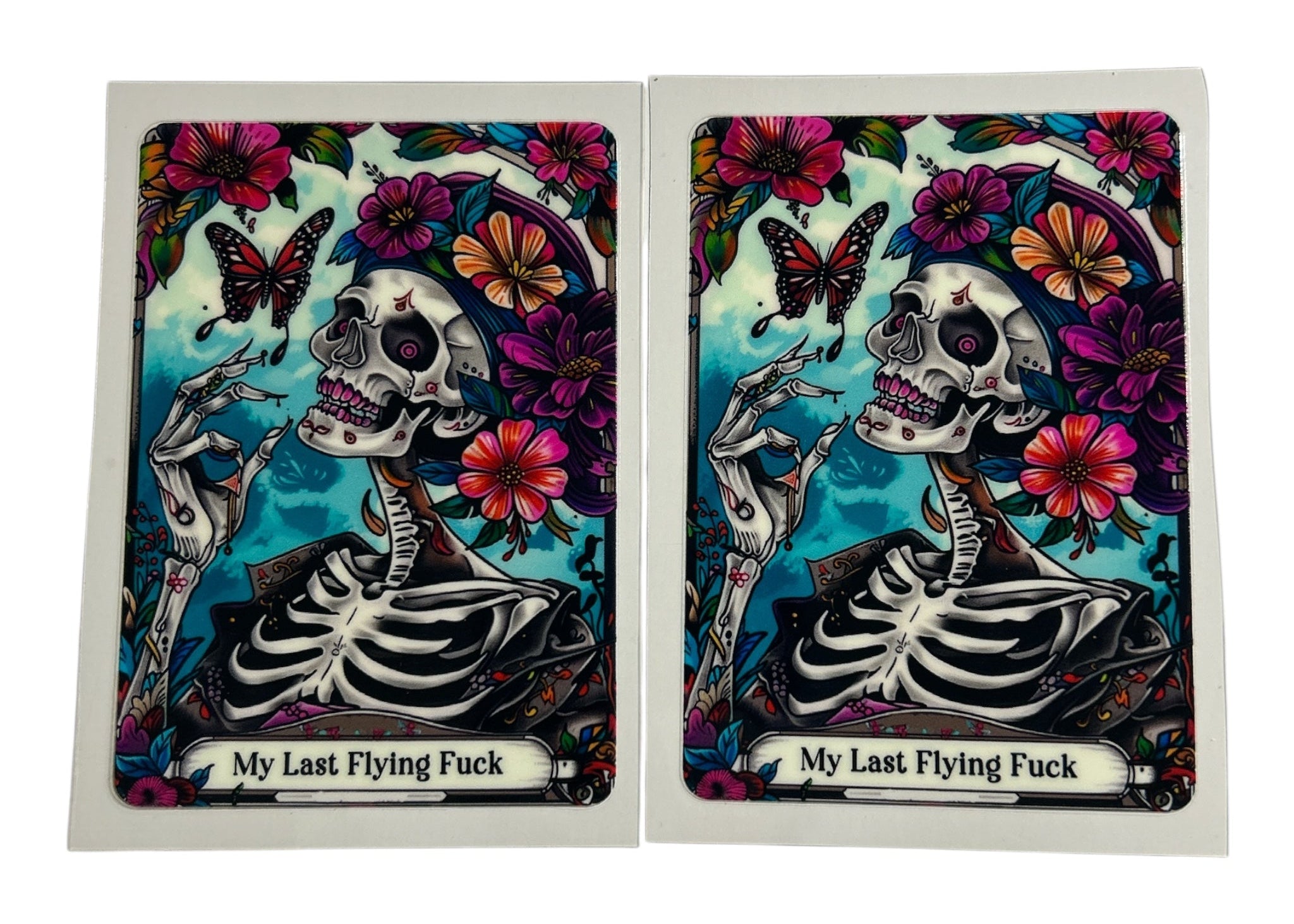 Tarot card cup decals featuring a skeleton with a butterfly and the text 'My Last Flying Fuck'