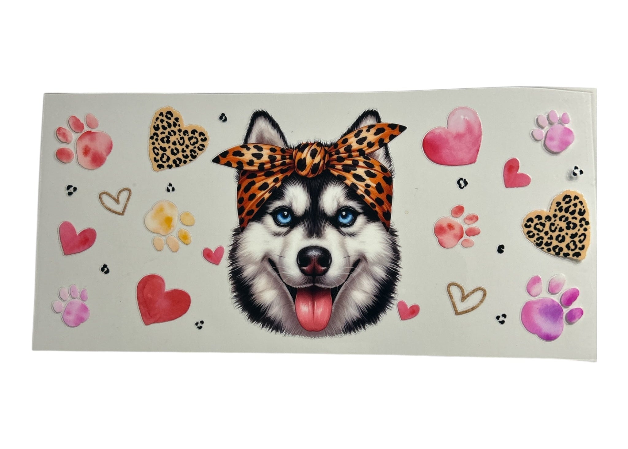 Sticker sheet with a dog wearing a leopard print headband surrounded by hearts and paw prints on a beige background.