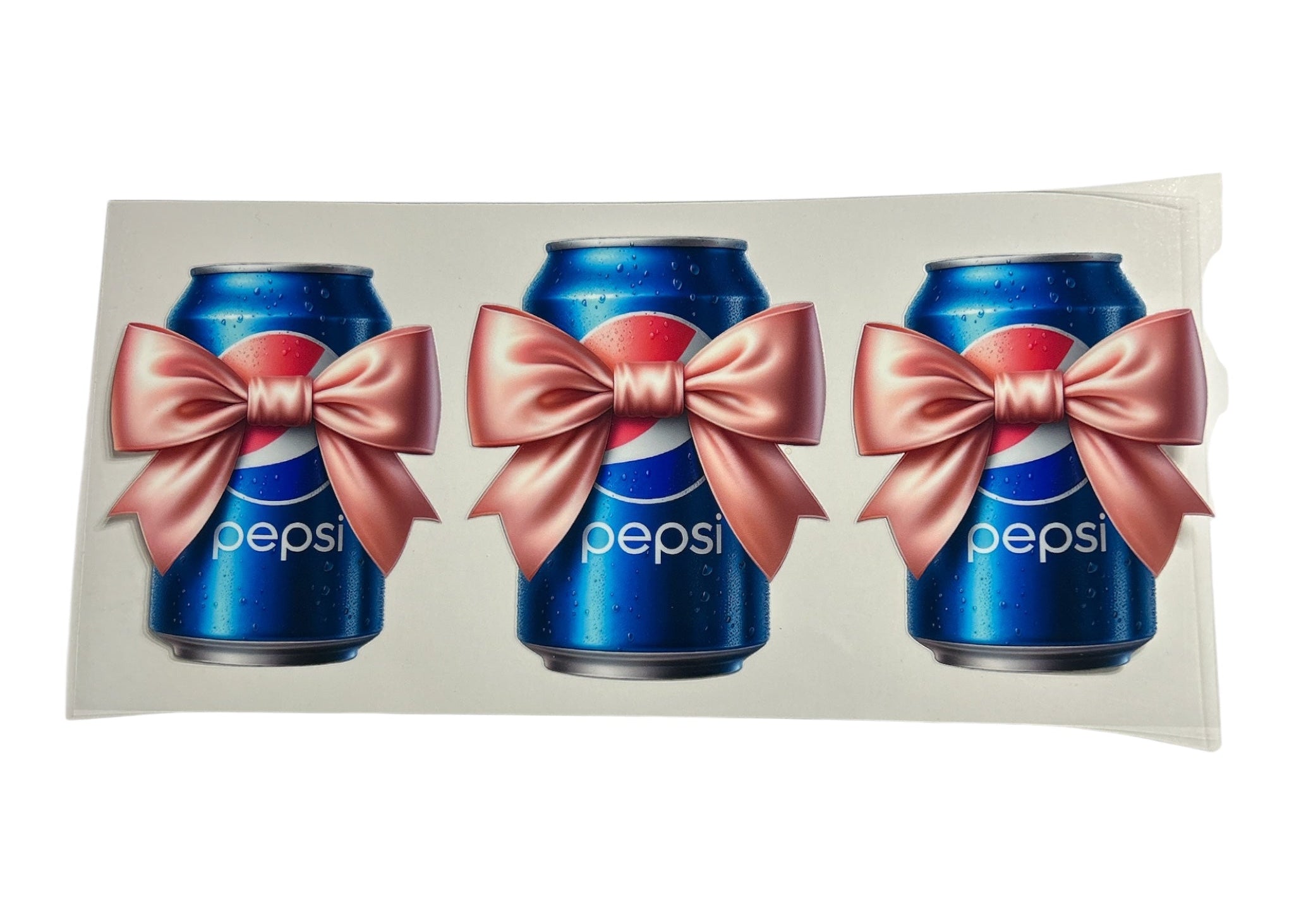 Three Pepsi cans with pink bows on a white background