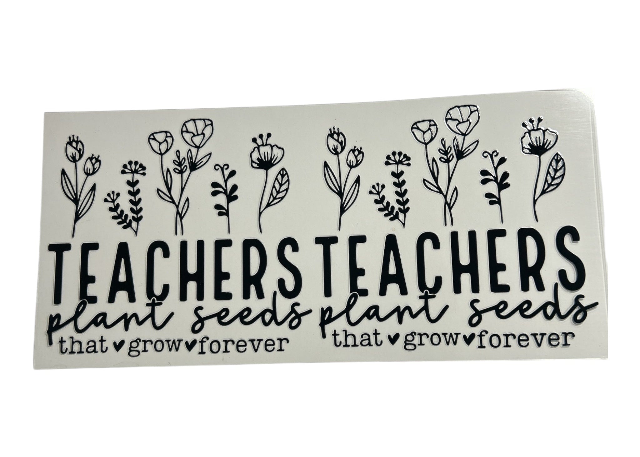 Decorative cup wrap with floral designs and 'Teachers Plant Seeds'text on a clear background