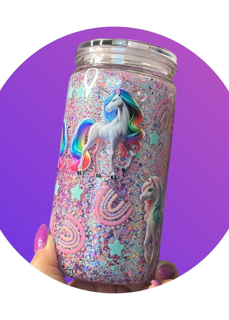 Tumbler with unicorn design held against a purple background