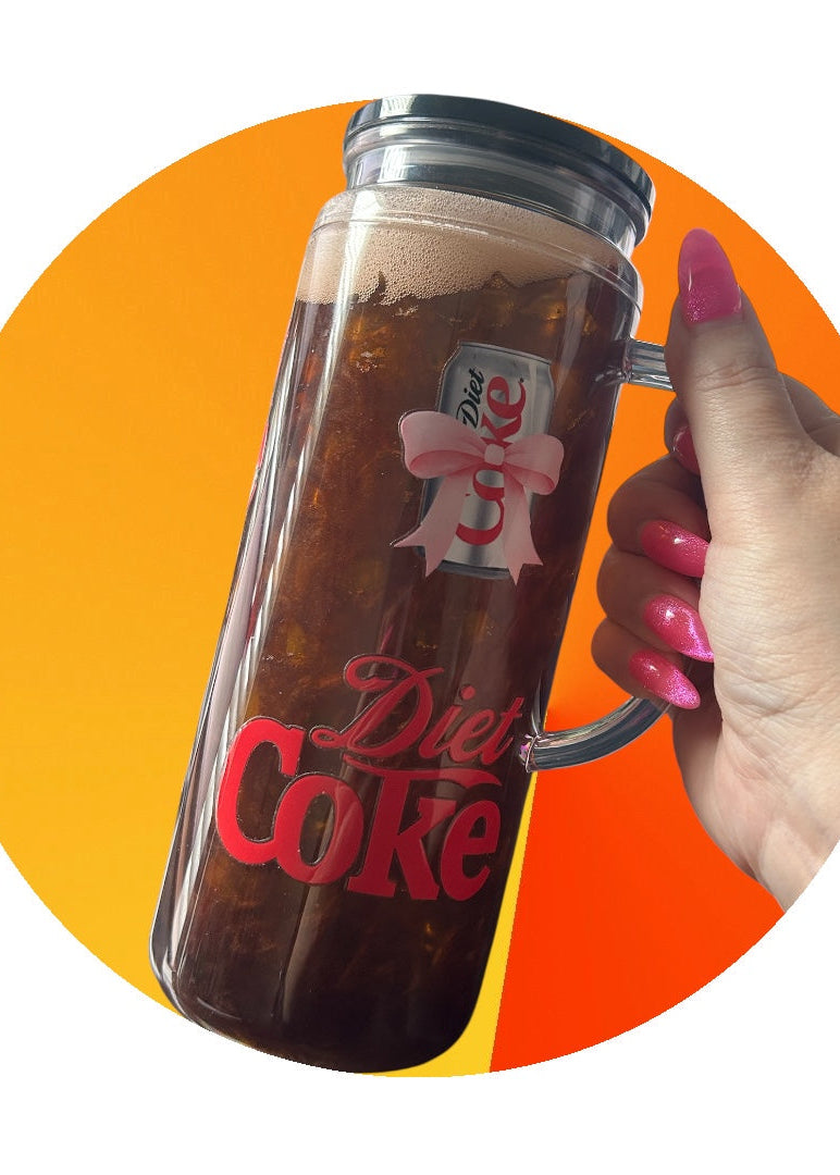 Hand holding a Diet Coke mug with a colorful background