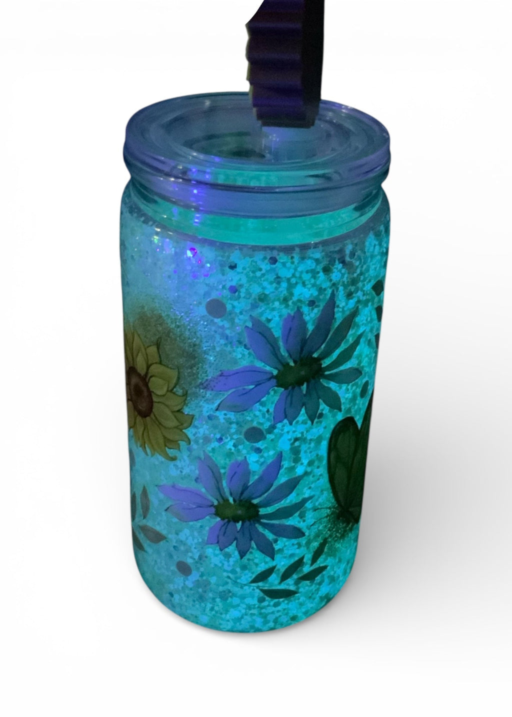 Tumbler with floral design and glow glitter on a white background