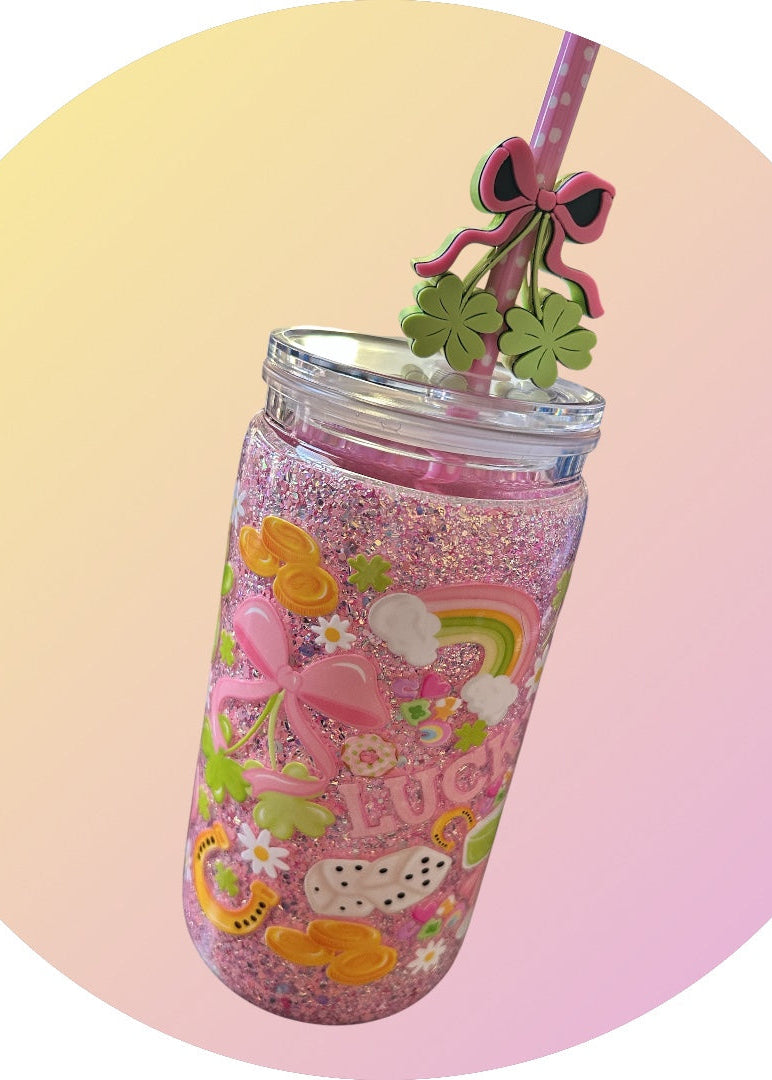Colorful tumbler with cartoon designs and a straw on a gradient background