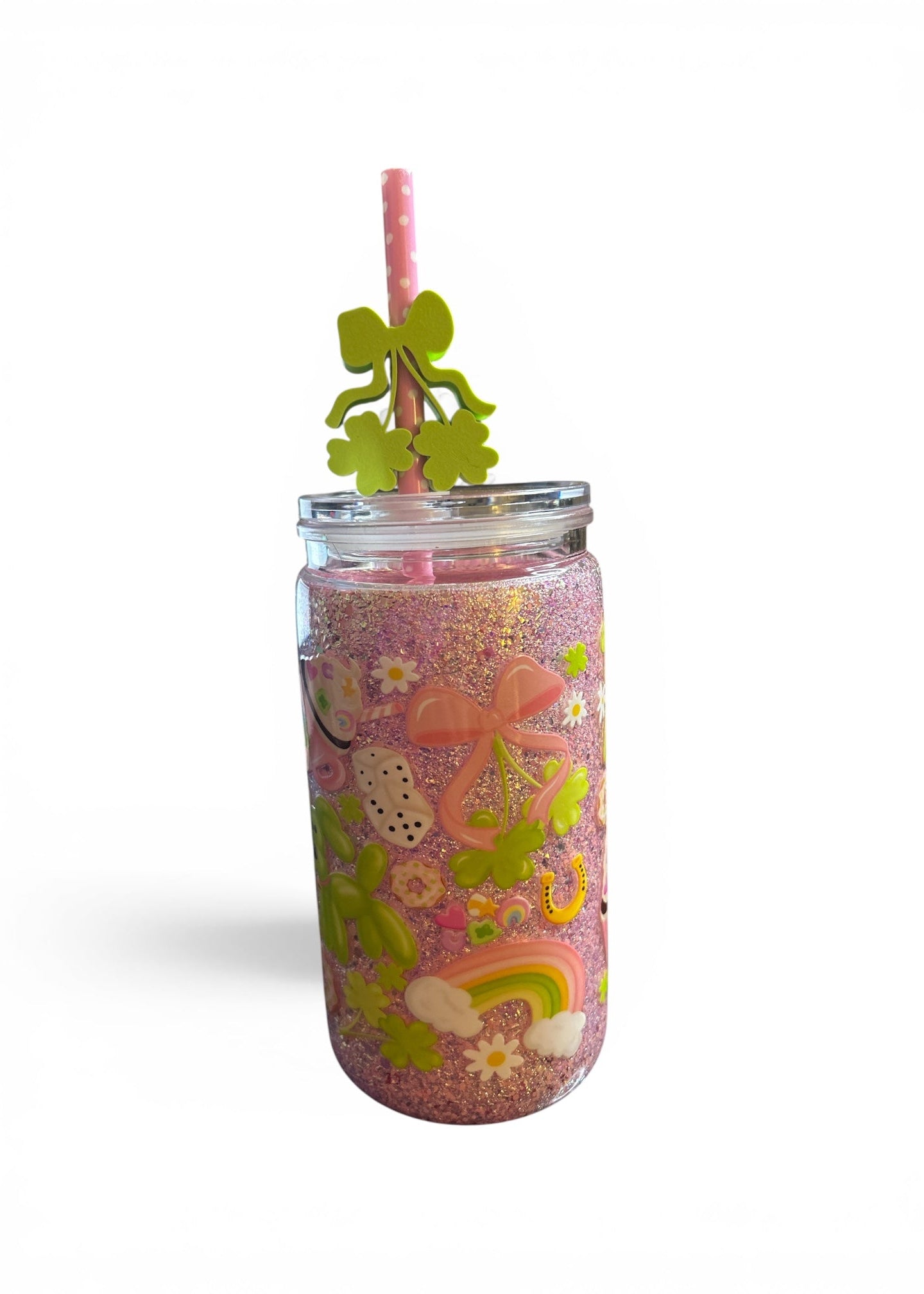 Close up of 16oz St. Patrick’s pink glitter acrylic tumbler with 3D shamrock embellishments and non-moving glitter fill