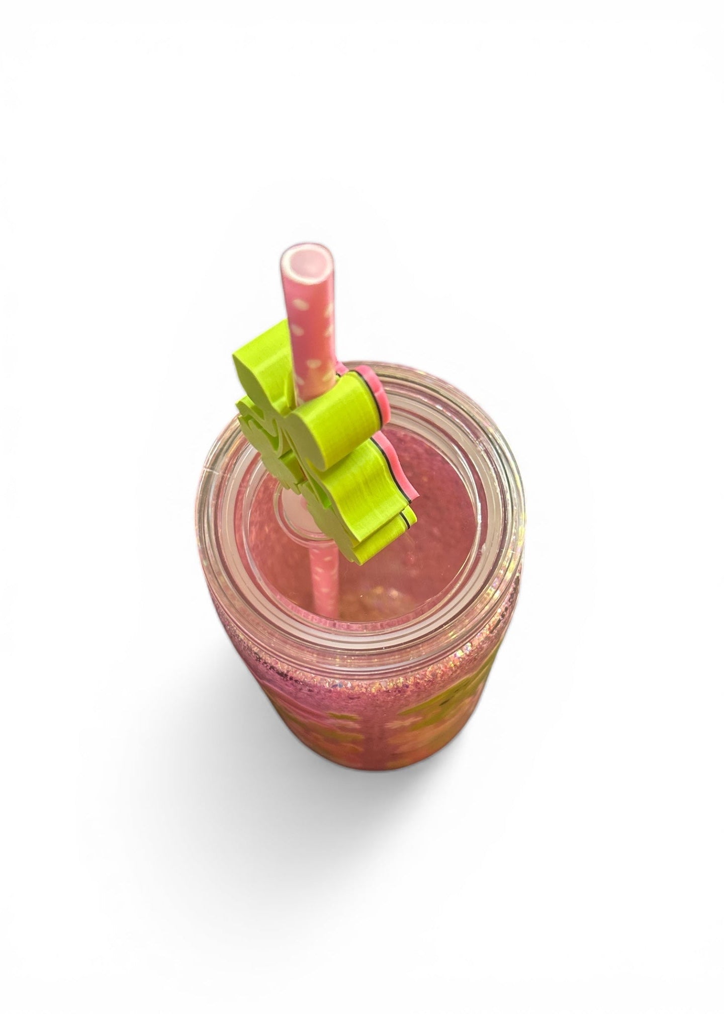 Close up of top of 16oz St. Patrick’s pink glitter acrylic tumbler with 3D shamrock embellishments and non-moving glitter fill