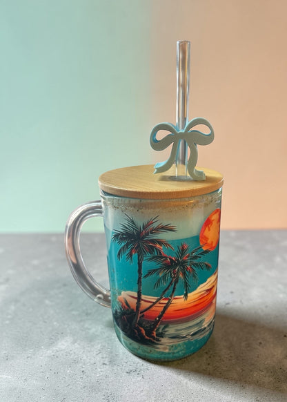 Tumbler with palm tree and sunset design on a neutral background
