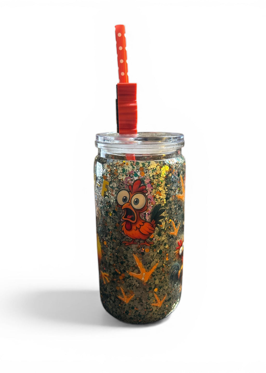 Glass tumbler with a colorful design of a cartoon character and red straw on a white background