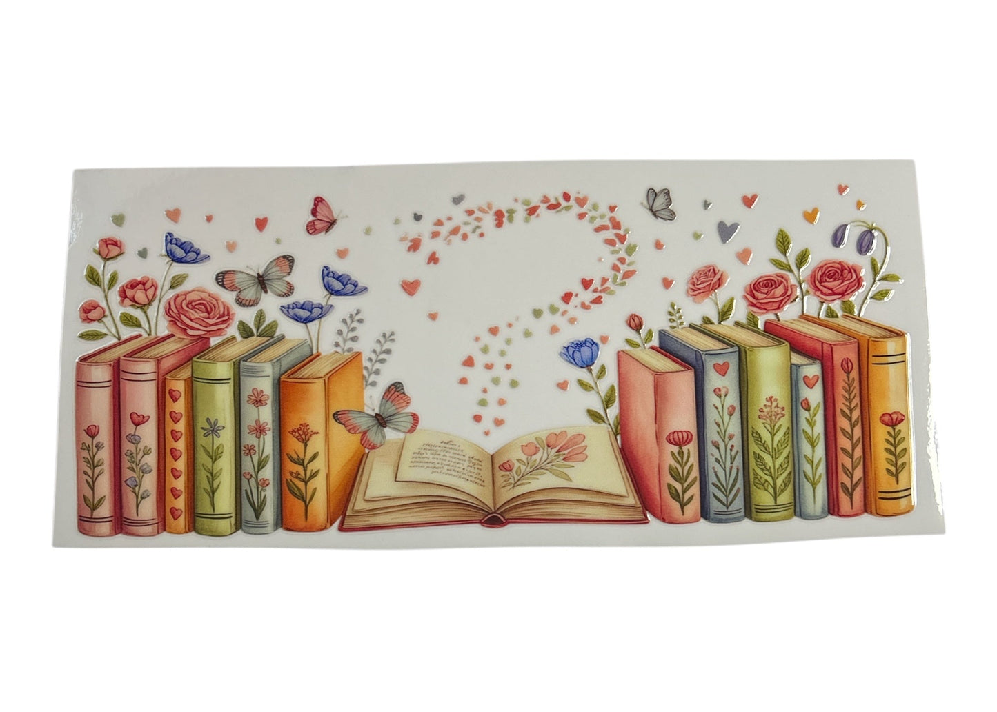 Decorative cup wrap with books, flowers, and butterflies on a white background