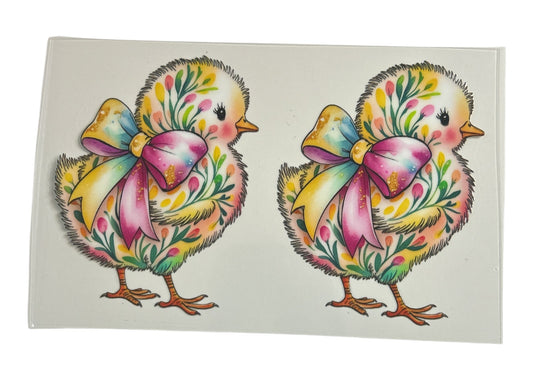 Two colorful chick illustrations with floral bows on a white background