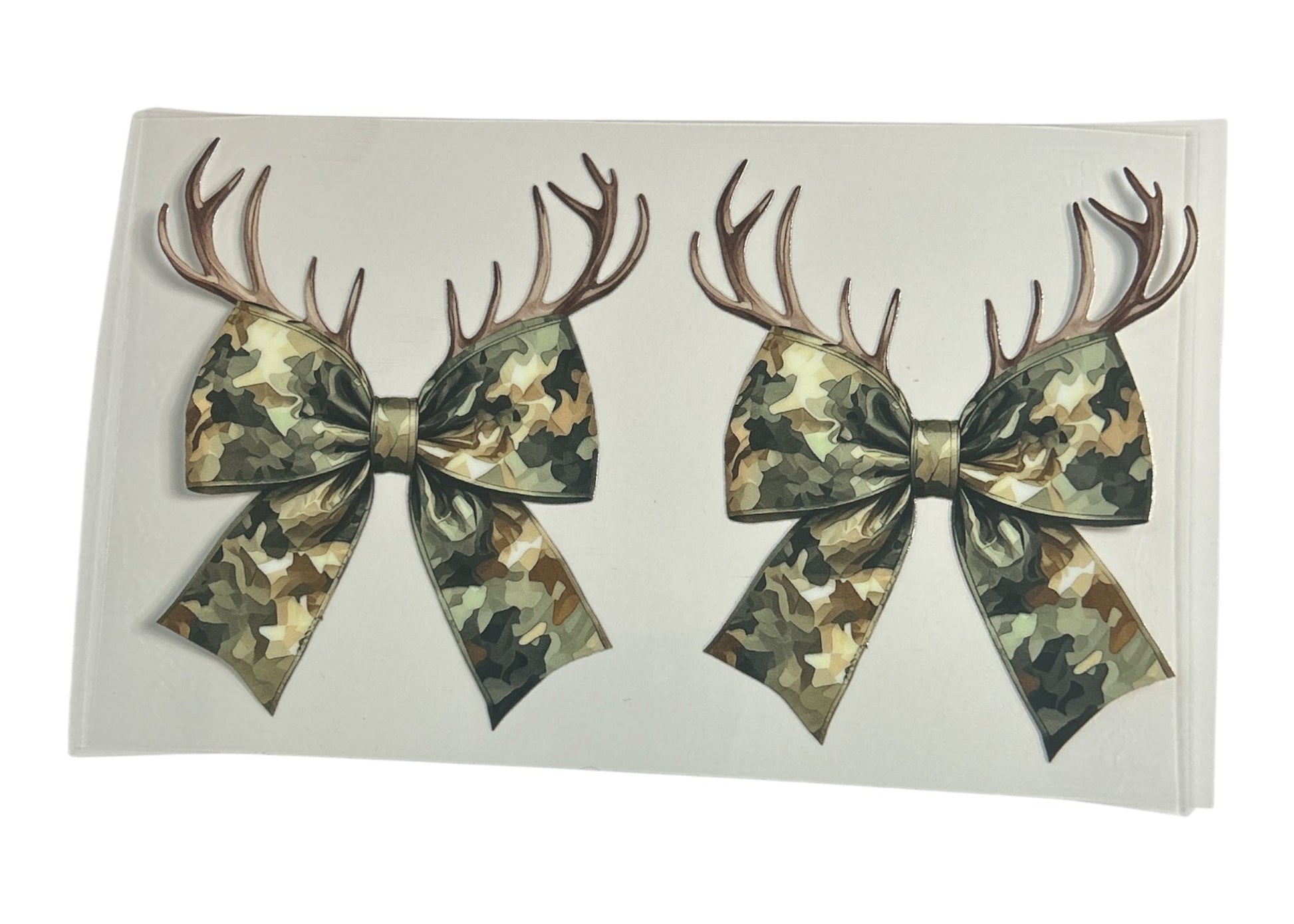 Two camouflage bows with antlers on a white background