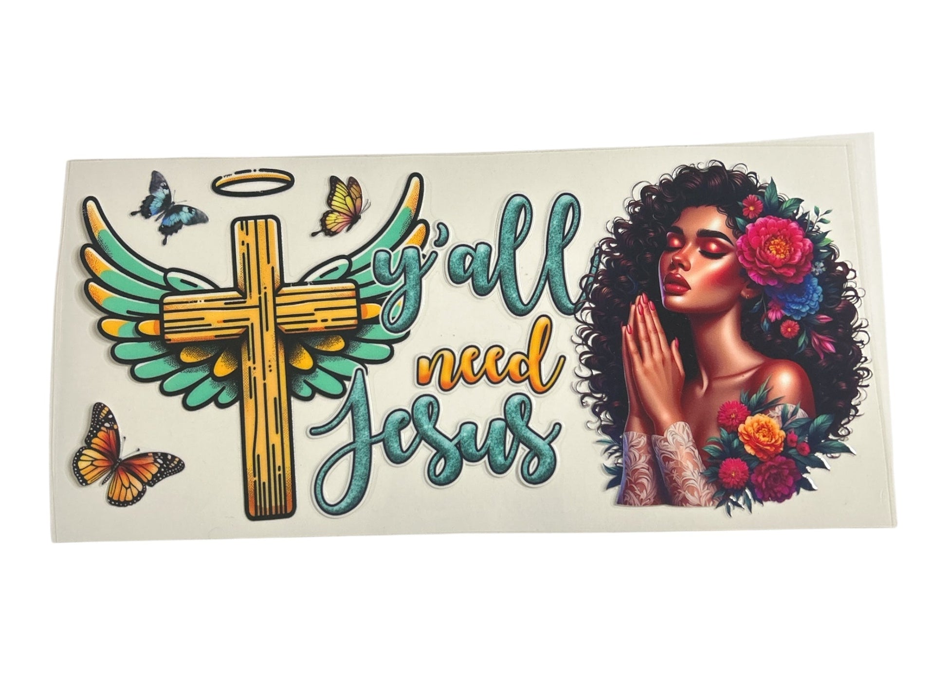 Decorative sticker with cross, wings, flowers, and text on a white background