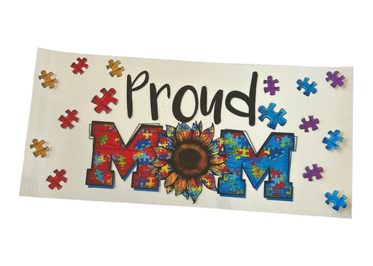 Decorative cup wrap with 'Proud Mom' text and colorful puzzle piece design on a clear background