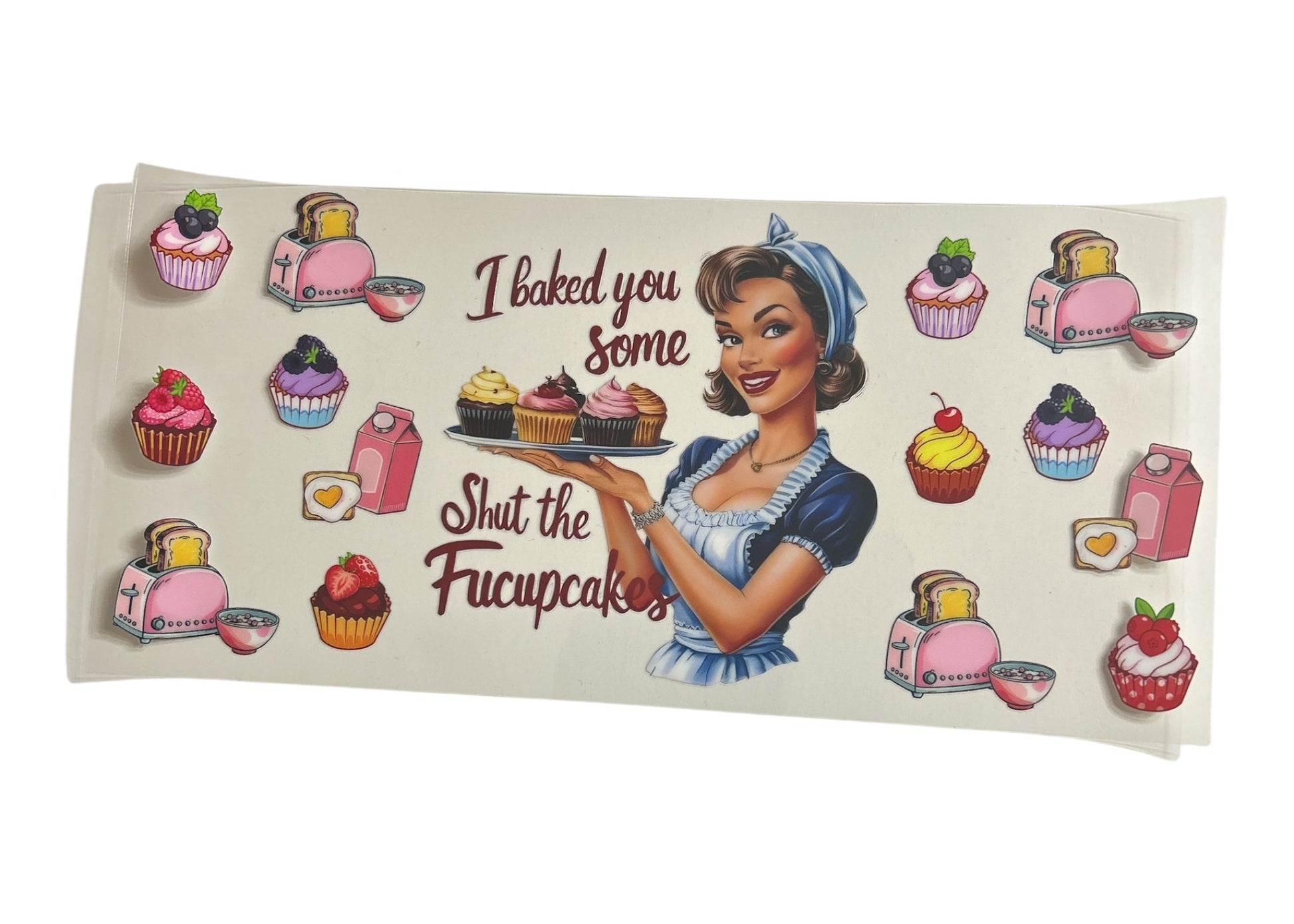 Cup wrap with a retro-style illustration of a woman holding cupcakes and text 'I baked you some cupcakes Shut the Fucupcakes' on a clear background